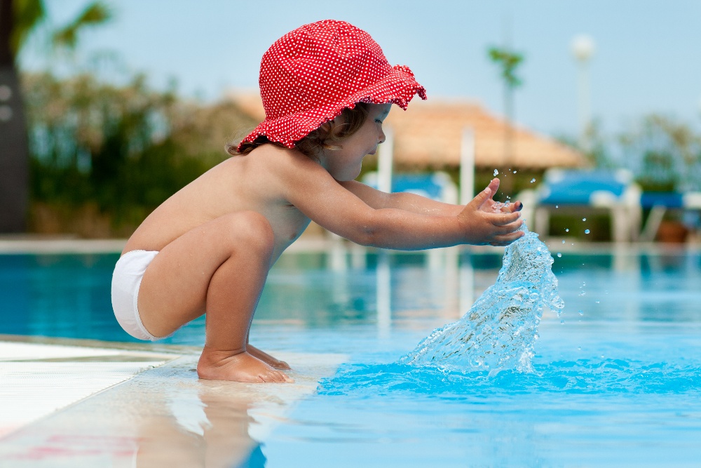 baby splashing in clean water, shutterstock paid